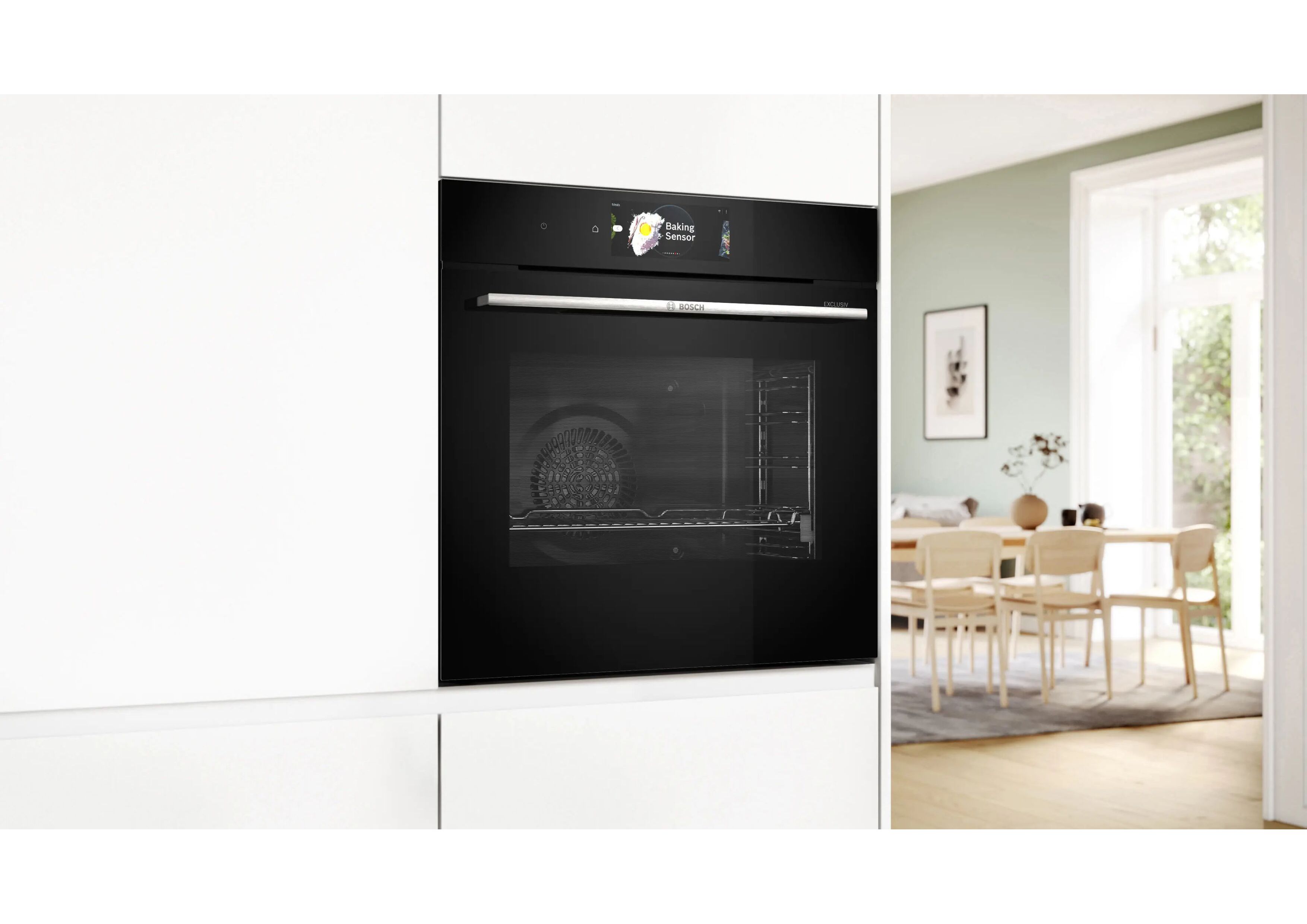 The closed black Bosch oven elegantly integrated into a handleless white kitchen