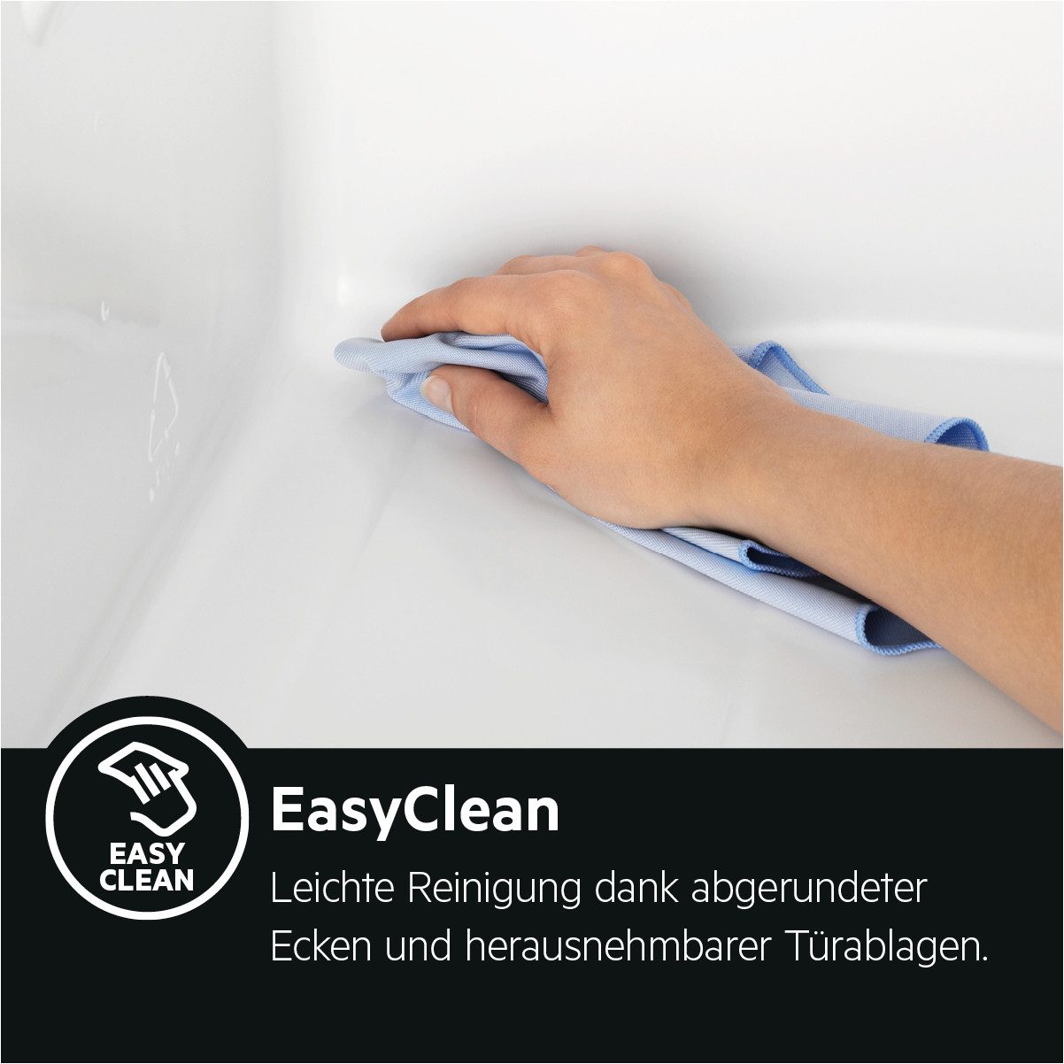A hand cleaning the smooth, rounded inner corner of the freezer compartment using a blue microfiber cloth.