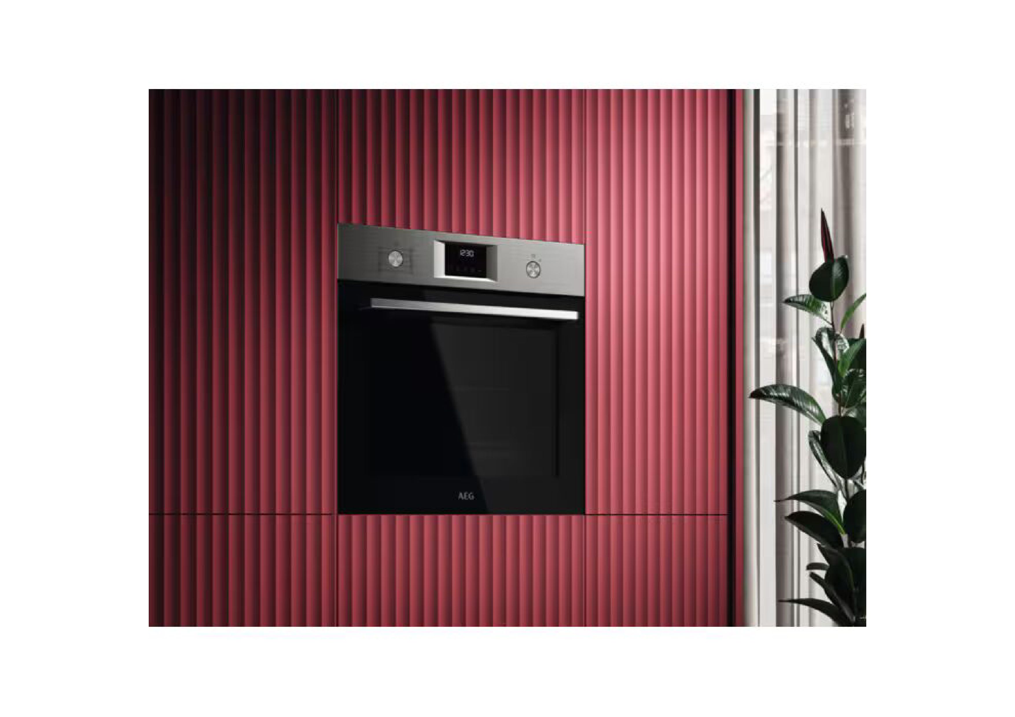 AEG oven built into a dark red slatted wall in a modern kitchen setting