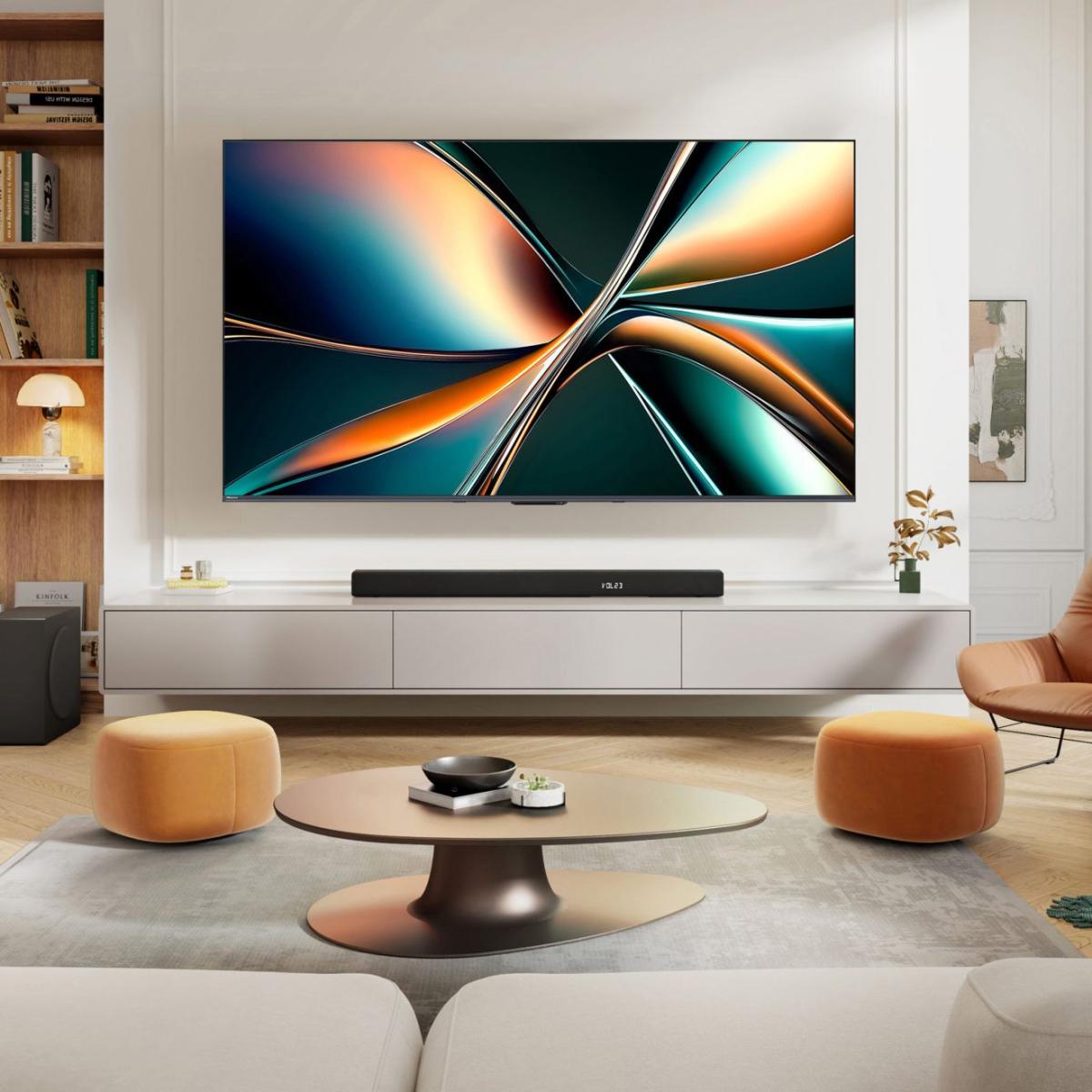Wall-mounted Hisense TV above a sideboard with a soundbar in a bright, modern living room.