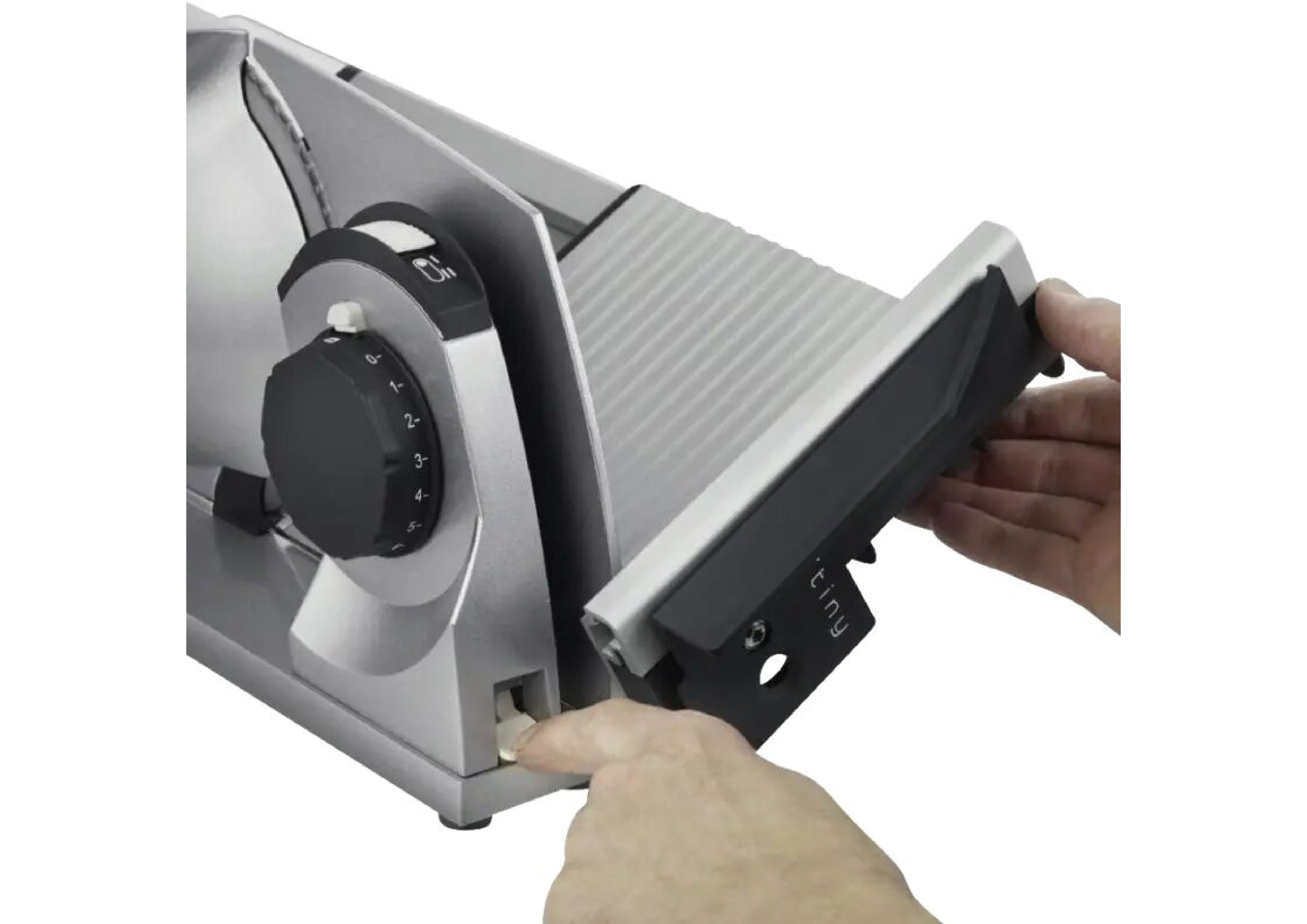 Hands pressing the release button to unfold the Graef food slicer