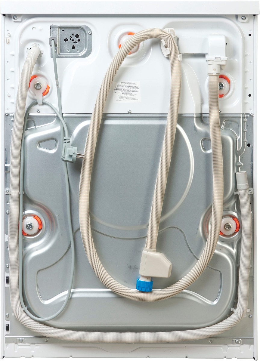 Rear view of the washing machine with water connections and drain hose.