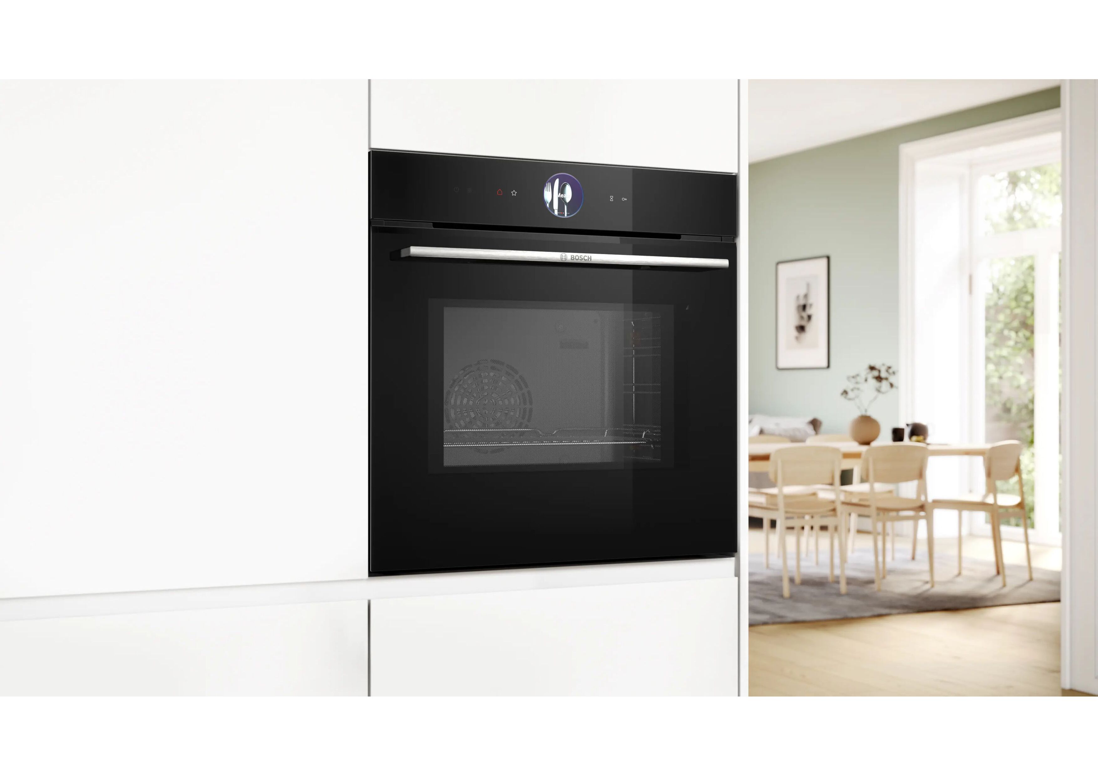 Bosch built-in oven closed in a modern white kitchen with a view into the living area.