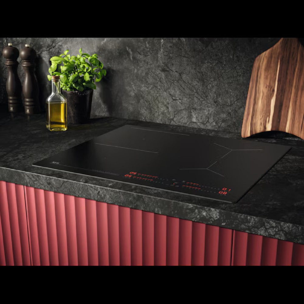 Modern kitchen design with AEG hob, herbs, and dark stone countertop with red fronts