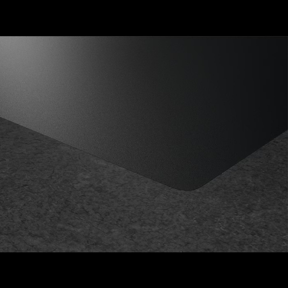 Detailed view of the flat hob corner on a dark gray natural stone countertop