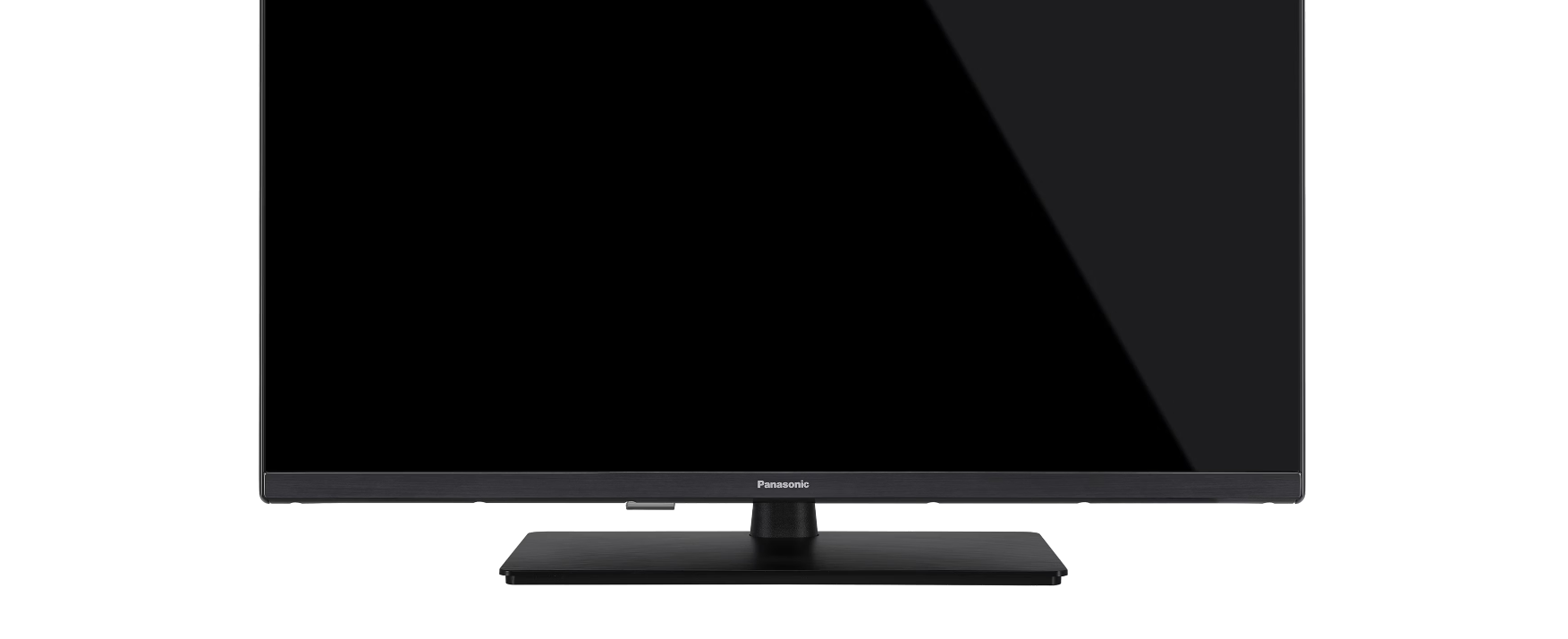 Nahaufnahme des unteren Teils eines schwarzen Fernsehers mit rechteckigem Standfuß.