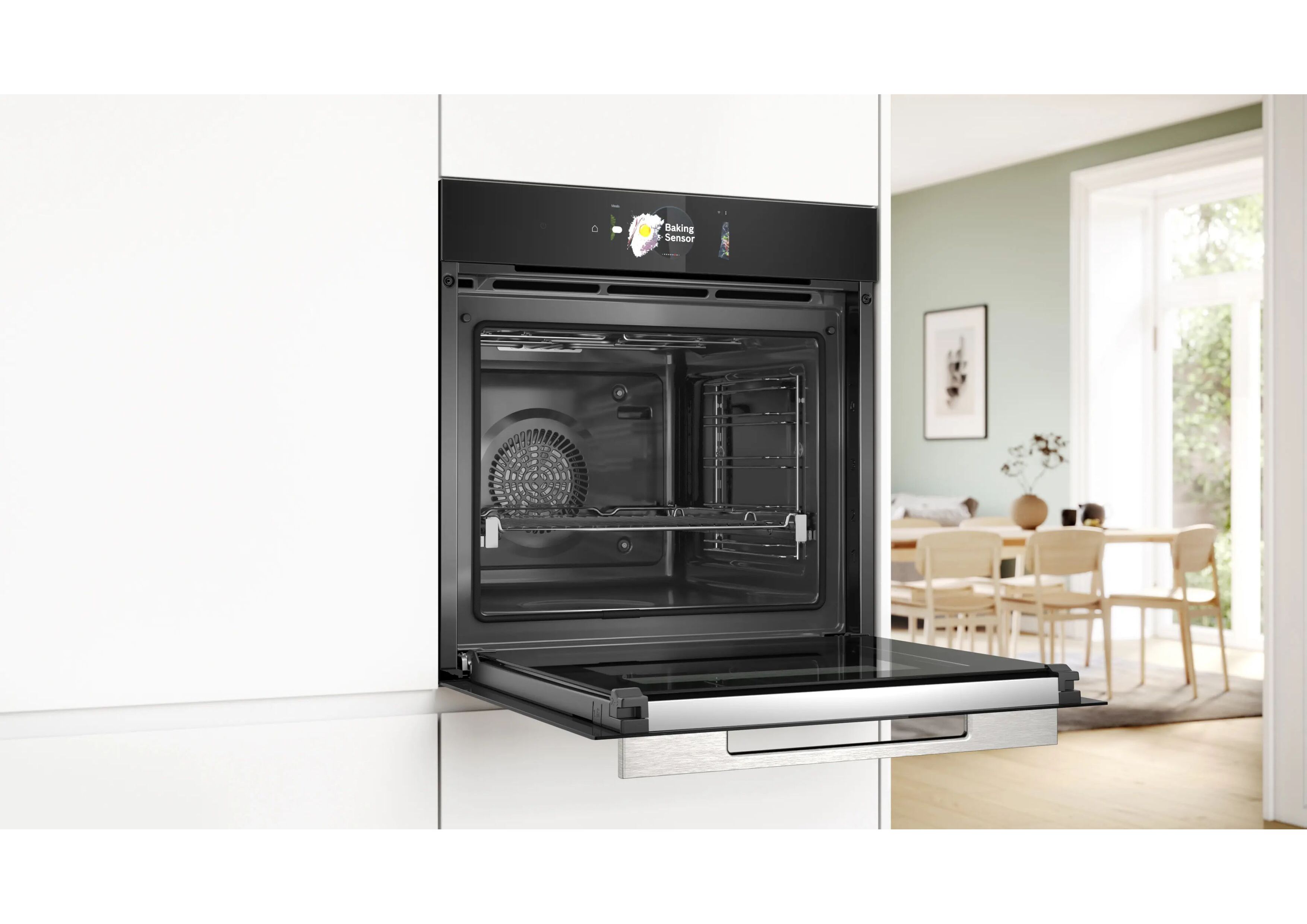 Oblique view of the open black built-in oven in a modern kitchen environment