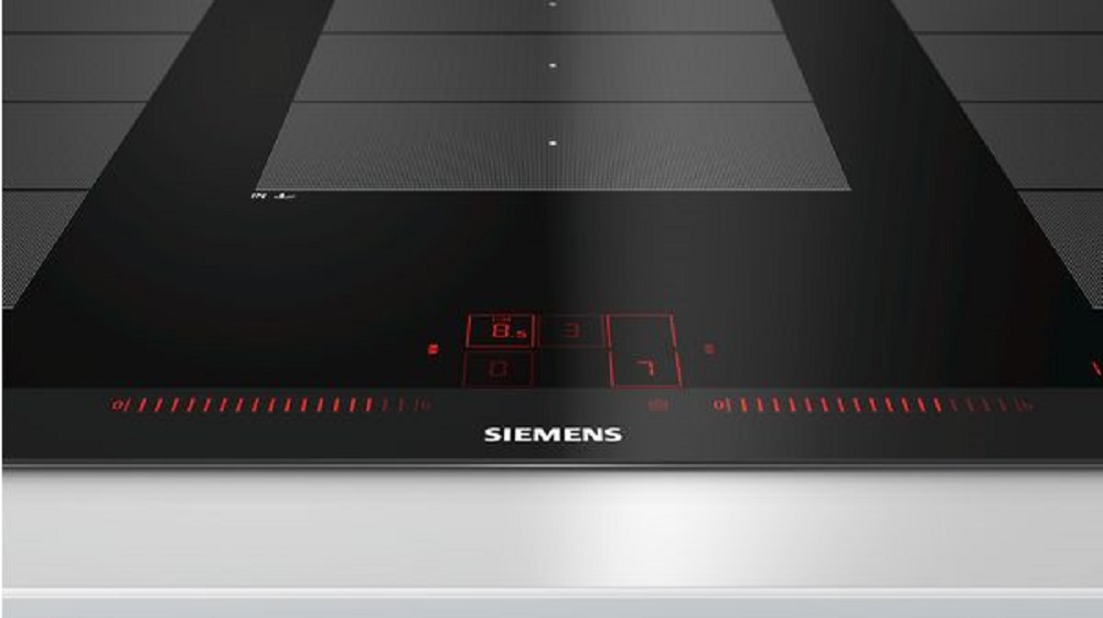 Nahaufnahme des Touch-Bedienfelds des Siemens EX975LXC1E Induktionskochfelds mit roten digitalen Anzeigen und Slider-Steuerung für präzise Leistungsregelung.