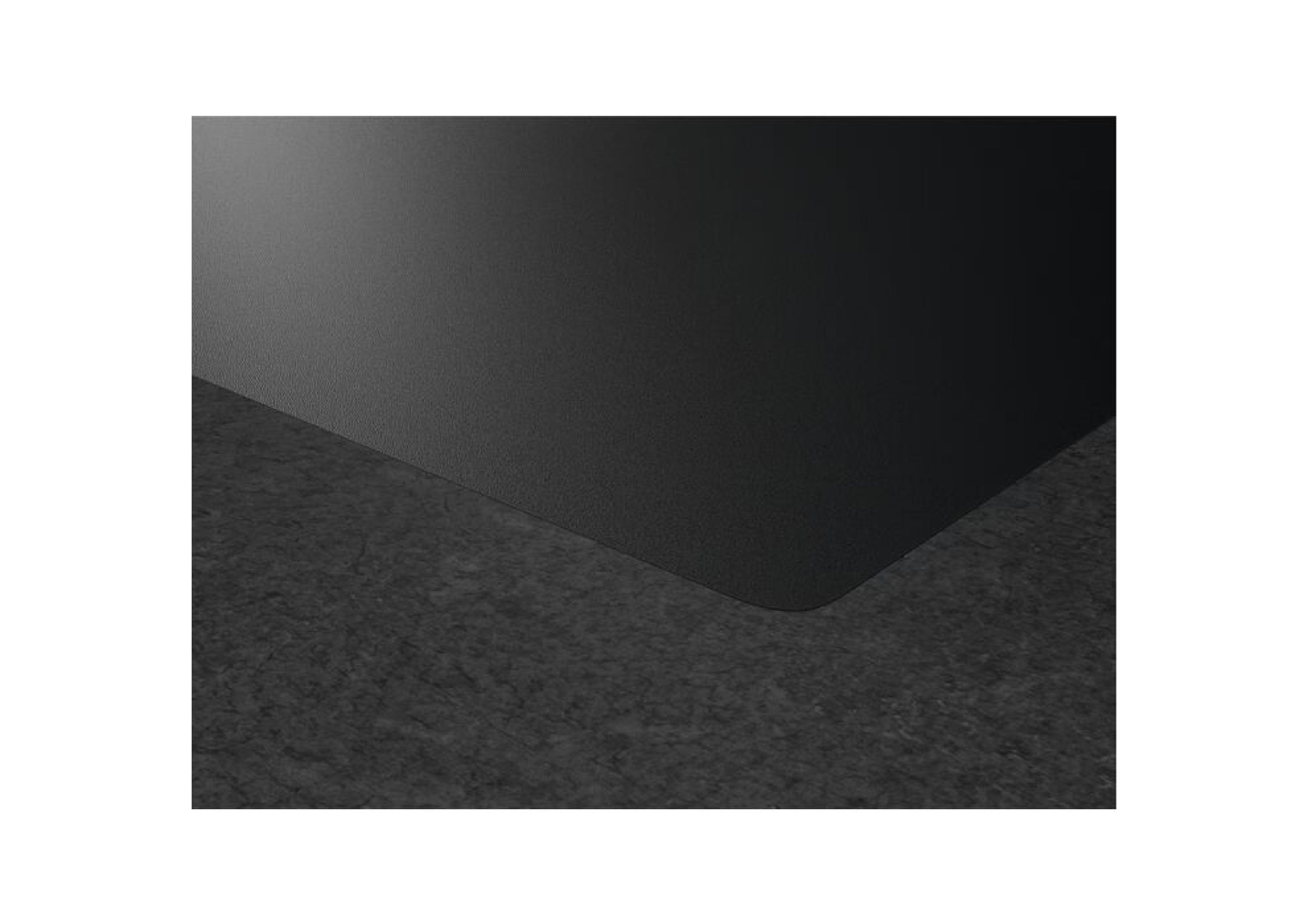 Close-up of the flush, rounded corner of the AEG hob built into a dark countertop.