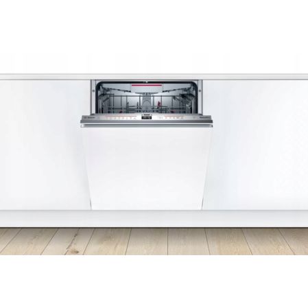 Fully integrated Bosch dishwasher in a minimalist white kitchen unit over light wooden flooring.