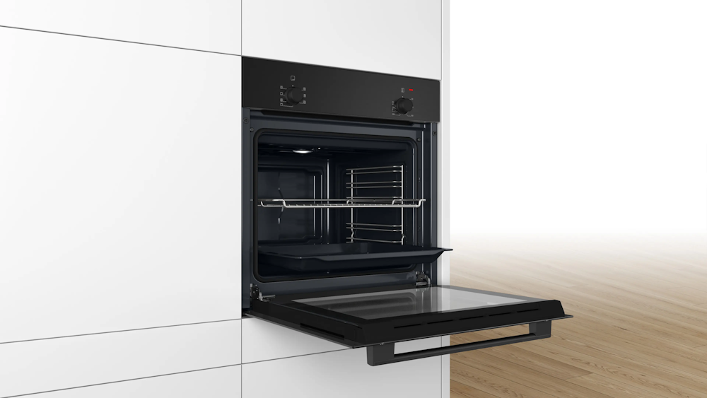 Bosch HBF010BA1 built-in oven with open door, installed in white kitchen cabinetry