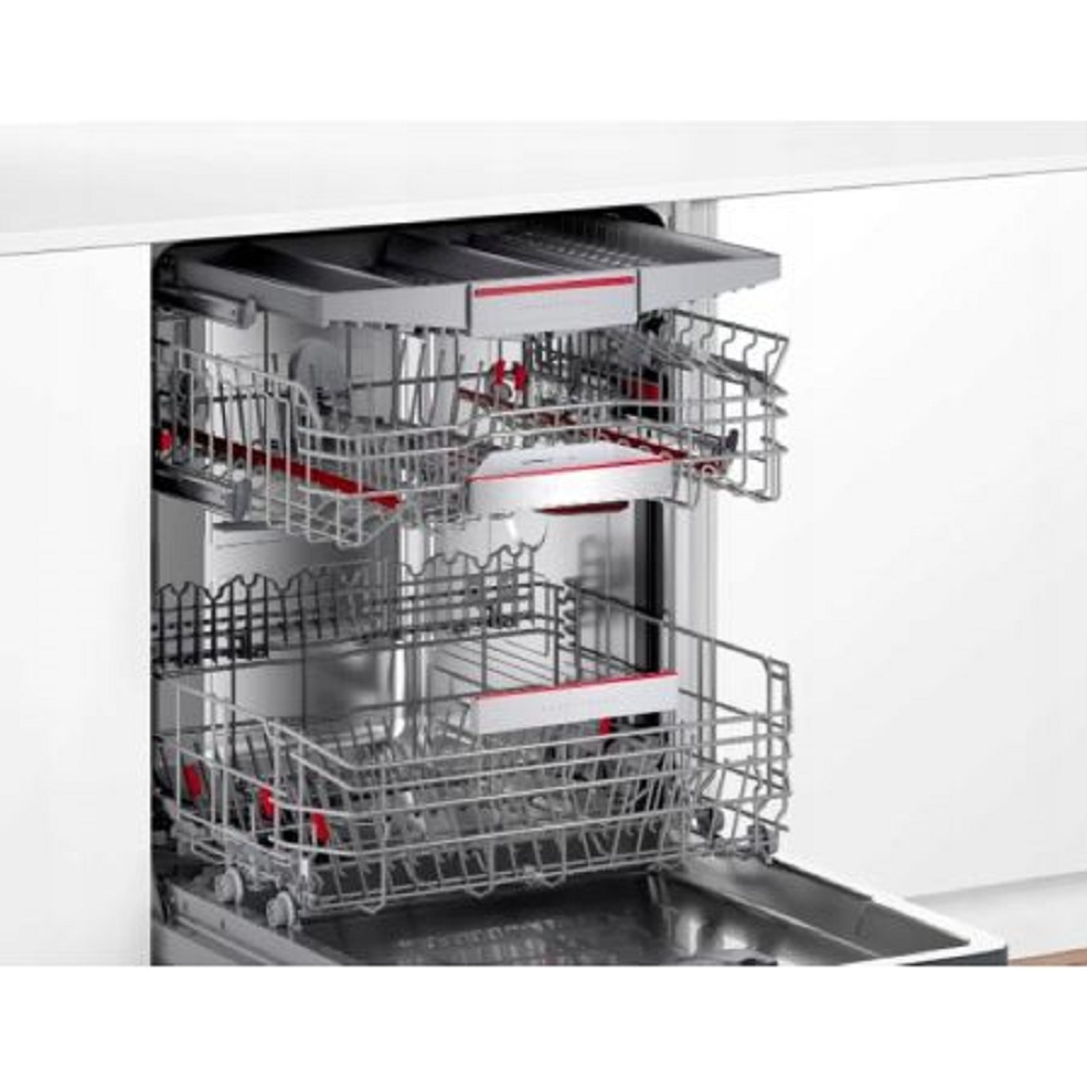 Interior view of the dishwasher with three extended, empty racks including the cutlery drawer.