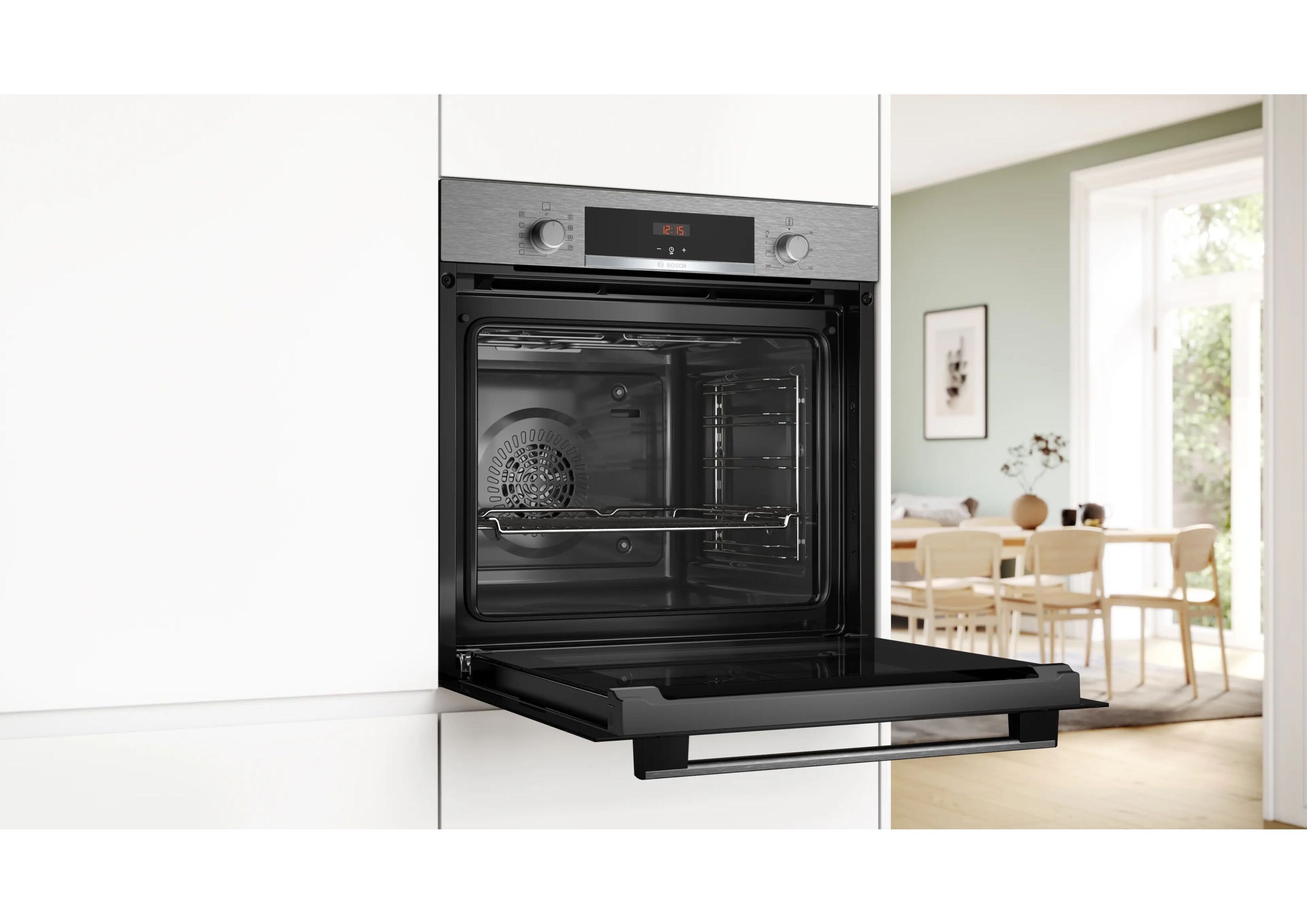 Open Bosch oven installed in a modern white kitchen unit.