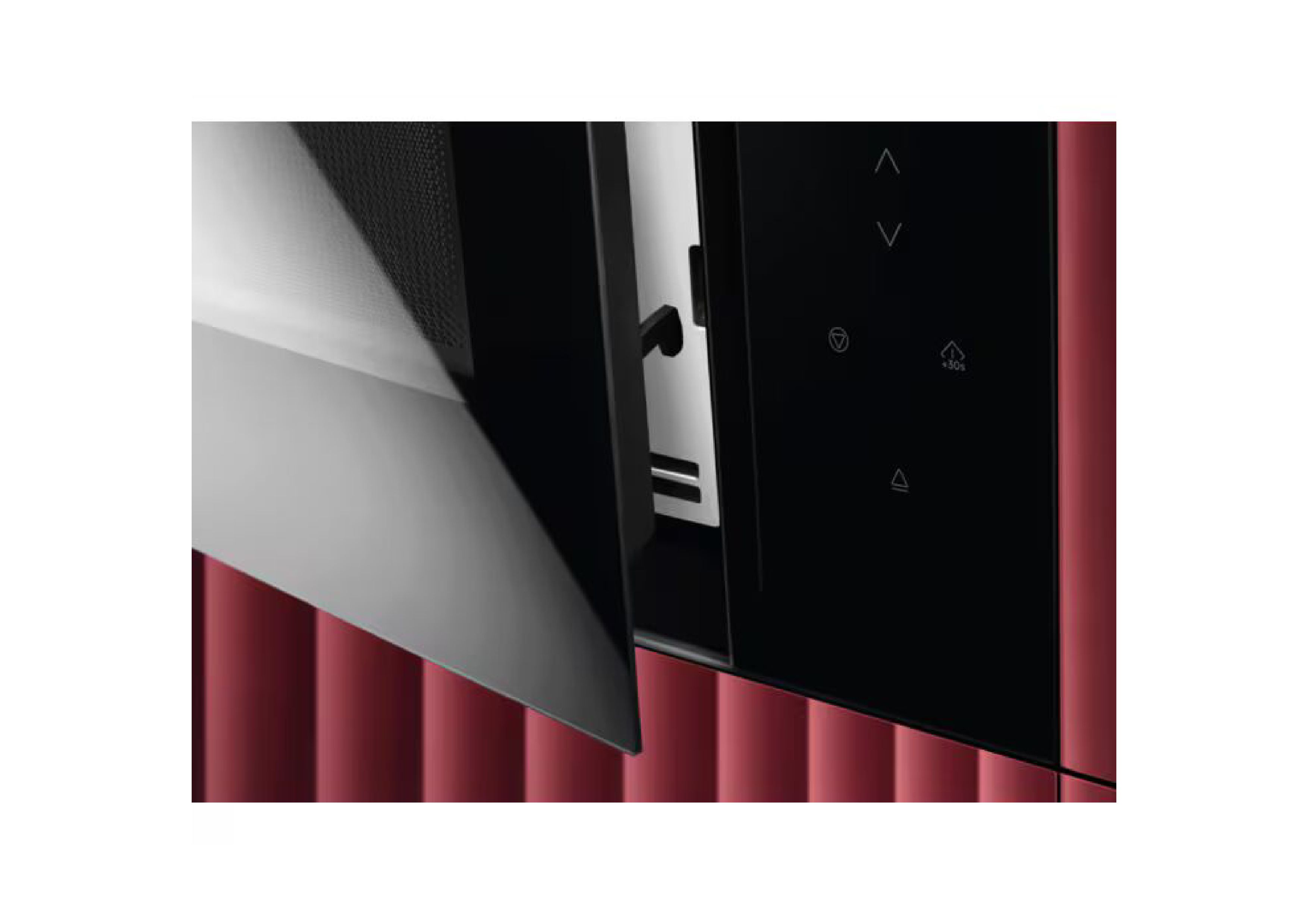 Detailed view of the slightly opened microwave door in front of a red slatted wall