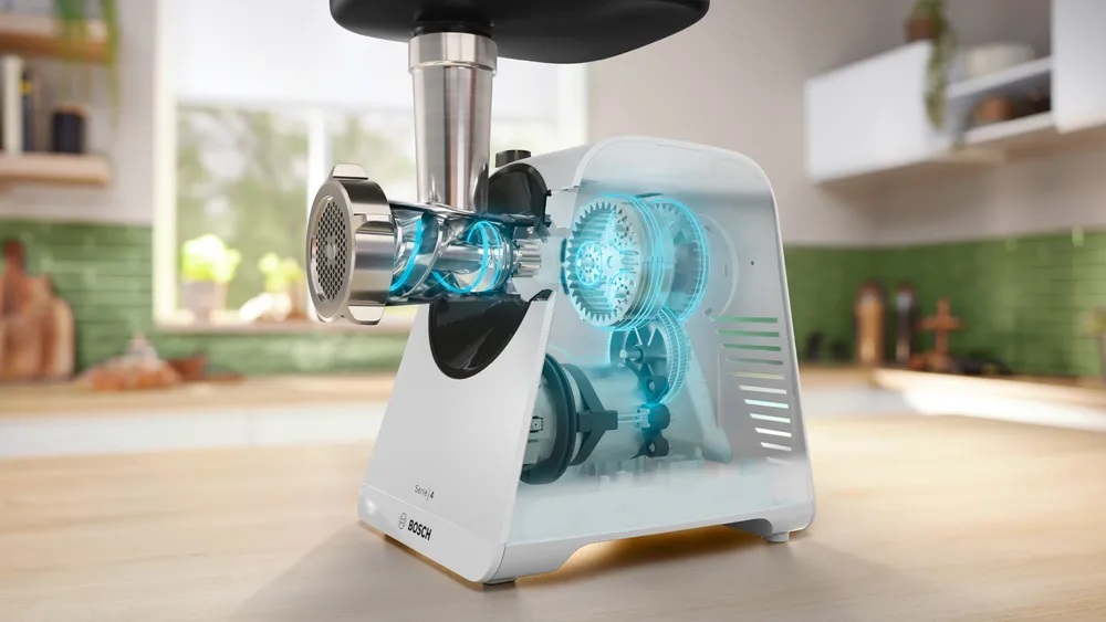 Transparente Ansicht des Bosch MFWS420W Kompakt-Fleischwolfs, die das leistungsstarke interne Getriebe und den Motor zeigt, die für eine effiziente Verarbeitung sorgen.