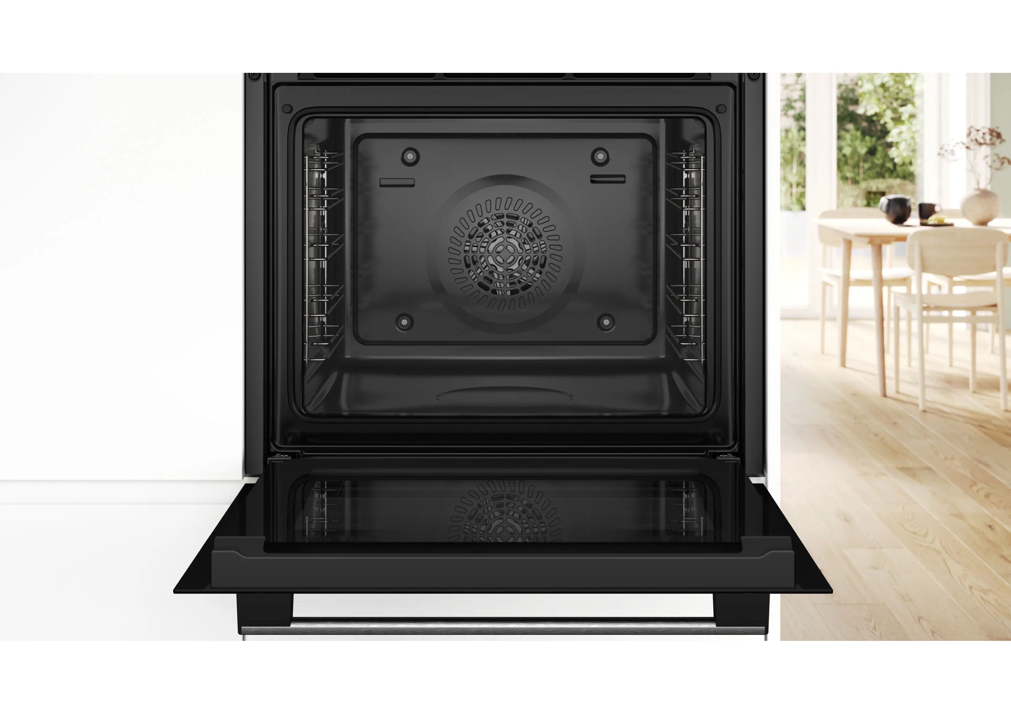 View into the empty, open cooking chamber of the oven with side shelf rails.