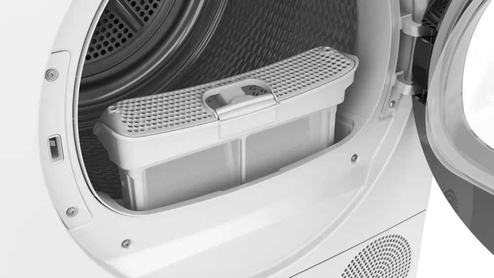 Herausnehmbarer Flusenfilter (Detail) Der vollständig herausgenommene Flusenfilter mit doppelter Siebstruktur, der zur einfachen Reinigung bereitsteht.